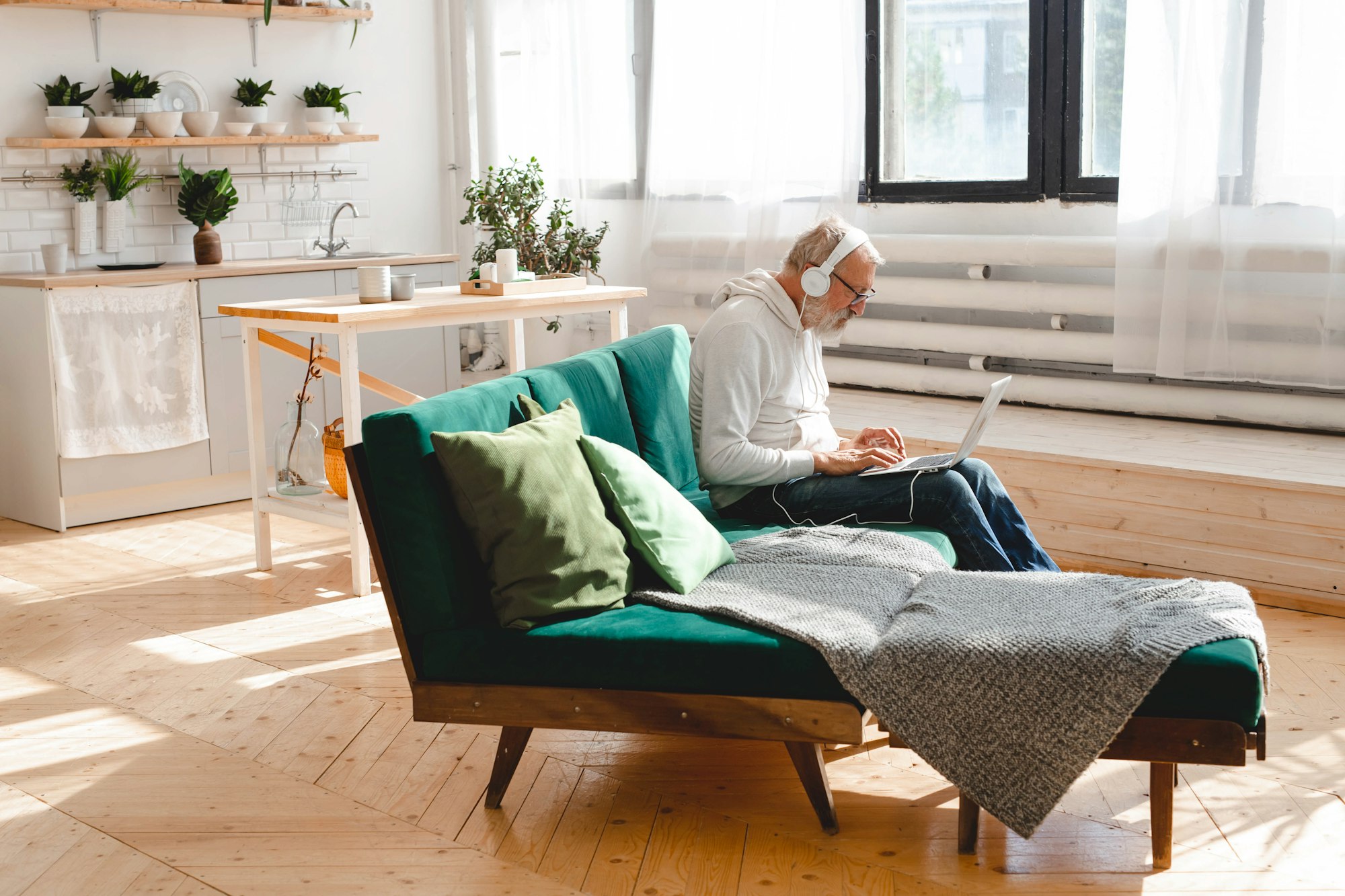 Senior elderly hipster man using phone while listening playlist music on mobile app - Elderly male